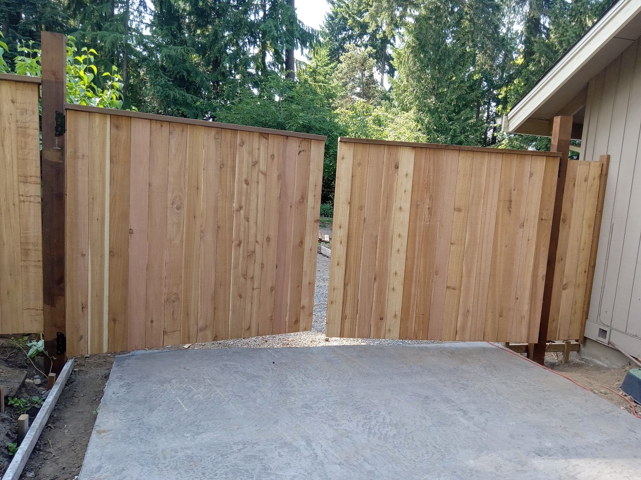 Cedar fence gate opened showing natural wood grain and craftsmanship