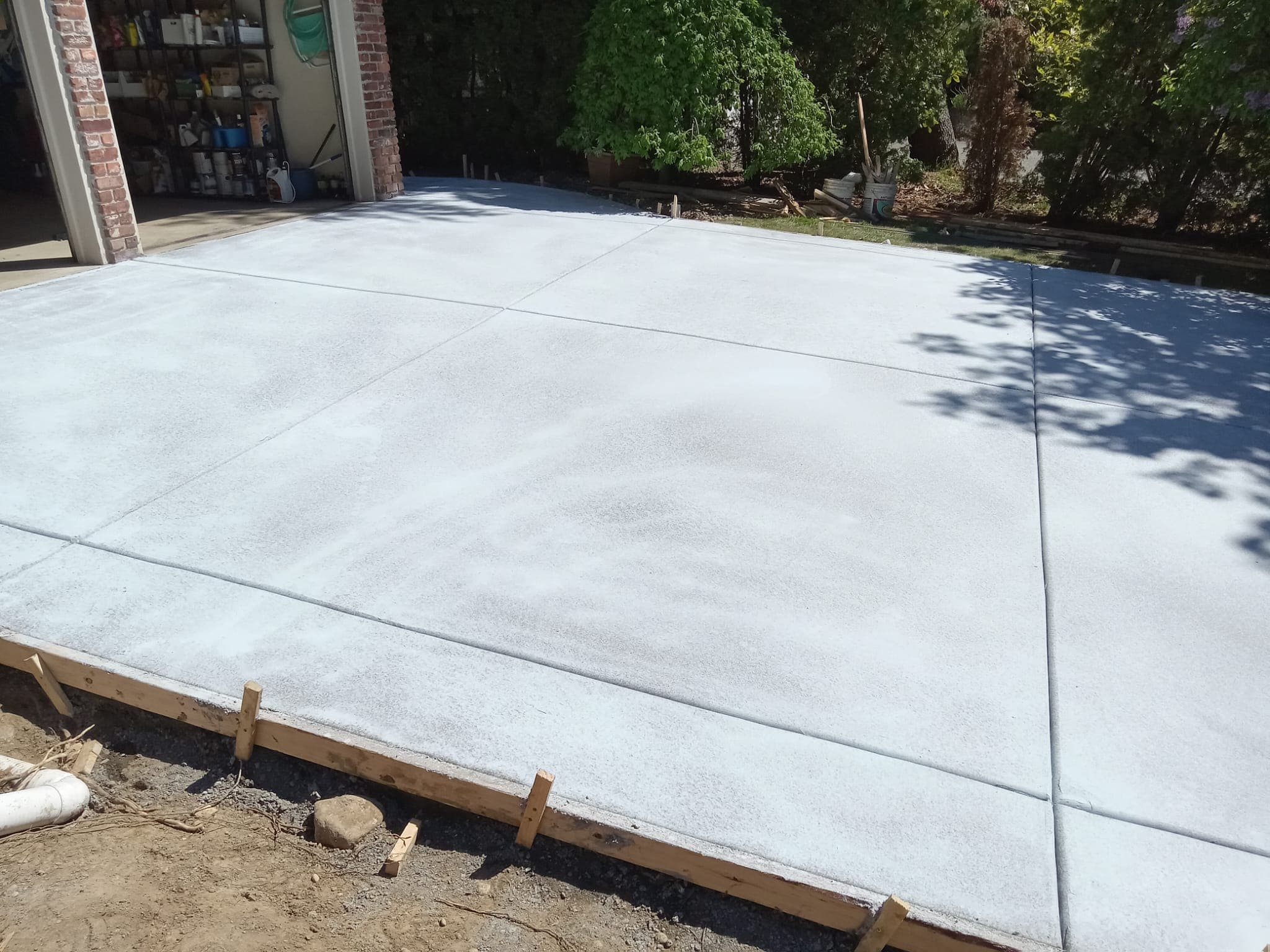Freshly poured concrete driveway with form boards still in place