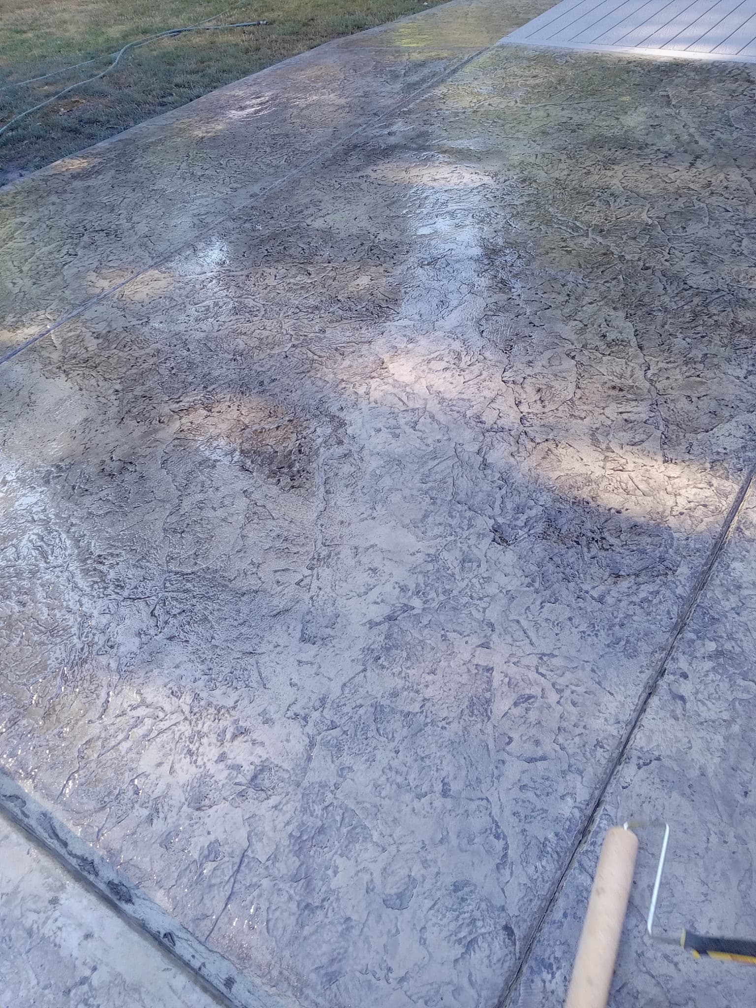 Close-up of stamped concrete with dark textured stone pattern